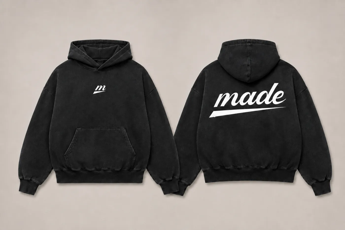 MADE Hoodie in black with the white m icon centred on the chest and the made wordmark at the back