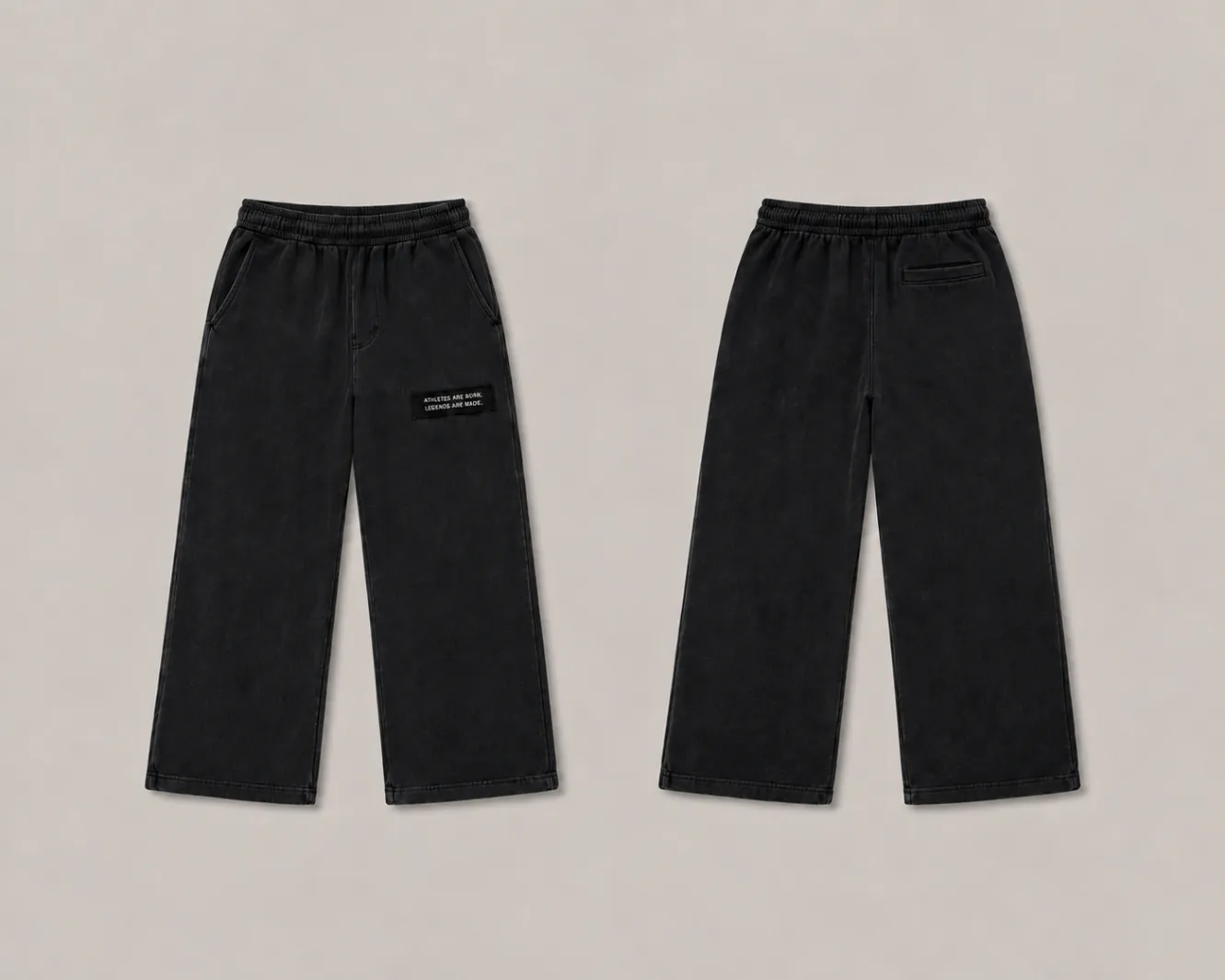 MADE Sweatpant in black, wide straight leg, with a black legacy patch on the wearer's left upper thigh