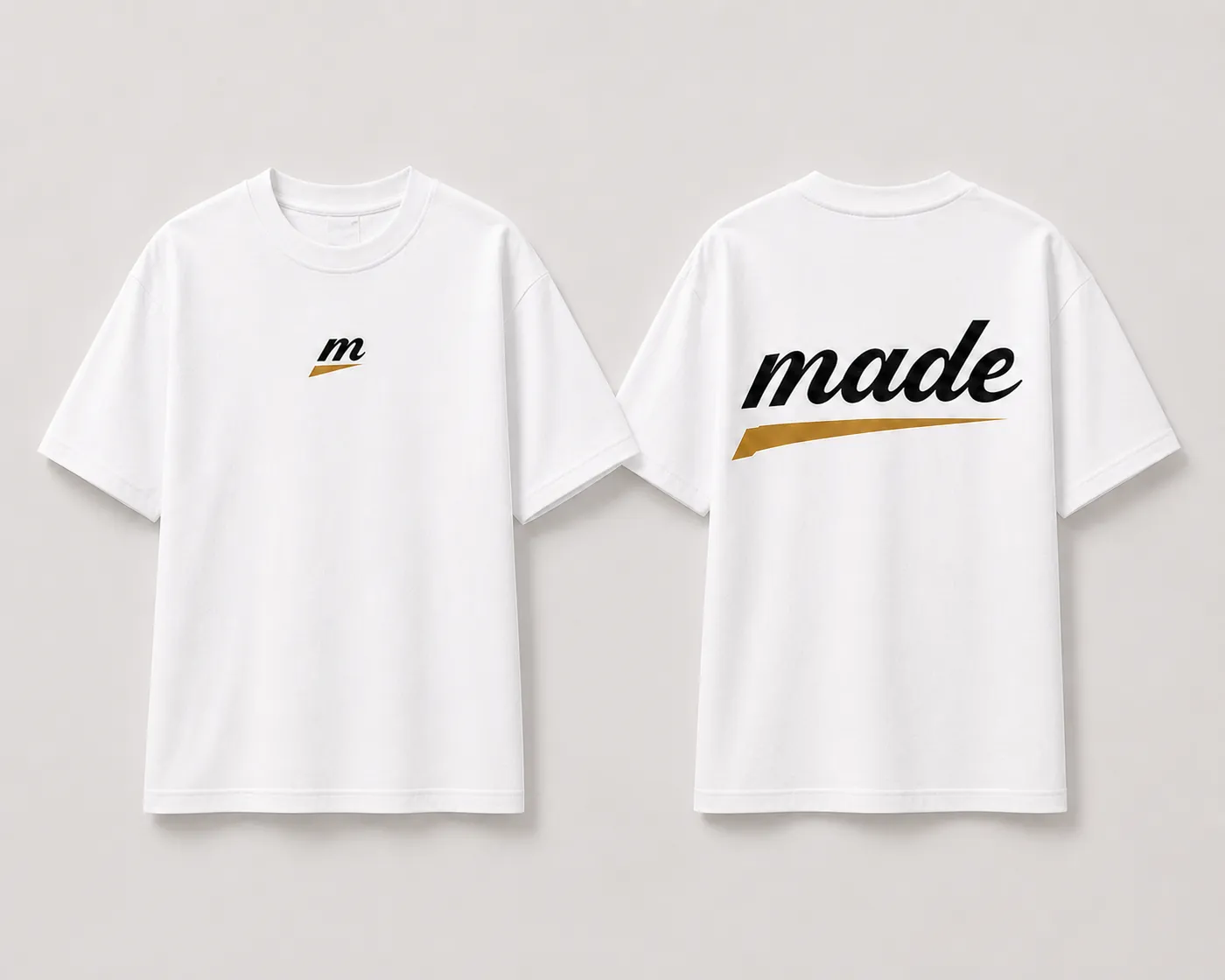 MADE Signature Tee in bone with the black m icon centred on the chest and the made wordmark with a gold glide underline at the back